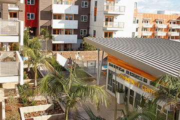 a supermarket with palm trees in front of an apartment building