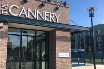 the front of a cannery store with a sign on the building