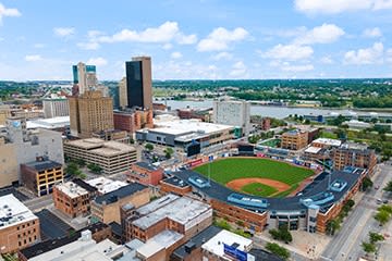 an aerial view of a city with a baseball field