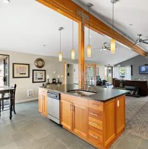 A kitchen with wooden cabinets and a large island.