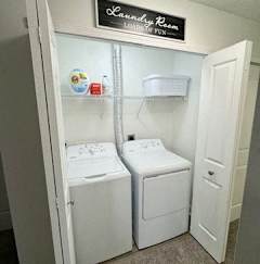 A laundry room with a sign that says "Laundry Room" on the wall.