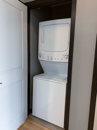 Full-size stacked washer and dryer included in in a 1 bedroom apartment for rent at The Flats at 84 apartments Lincoln NE 68516