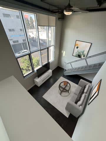 A living room with a grey couch and a coffee table.