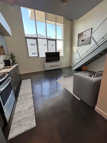 A modern kitchen with a staircase leading to the upper floor.