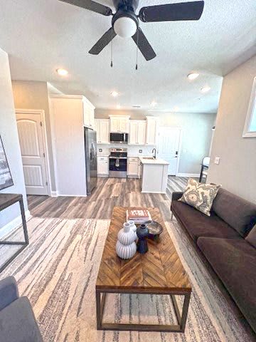 A living room with a brown couch and a wooden coffee table.