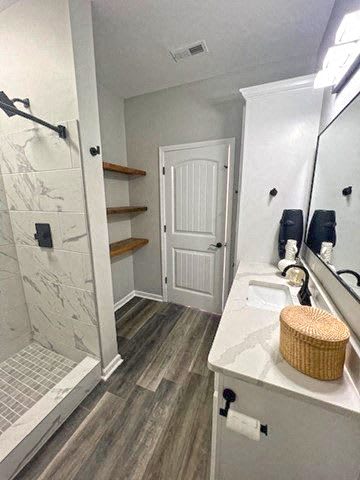 A bathroom with a white sink and a white door.