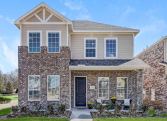 a home with a brick exterior and a black door