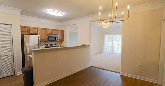 A kitchen with wooden cabinets and a refrigerator.