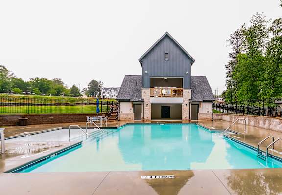 A pool in front of a house.