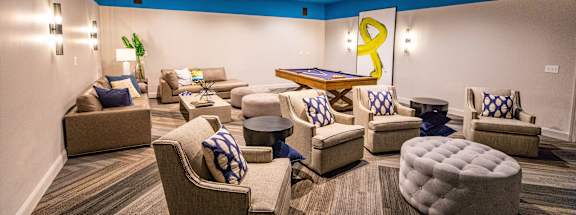 A living room with a blue ceiling and furniture.