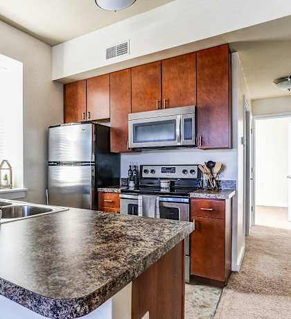 a kitchen with stainless steel appliances and granite counter tops