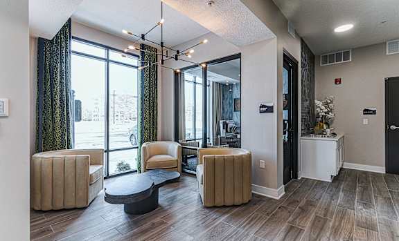 A living room with a large window and a view of the street outside.at Tiffany Flats, Ohio, 43231