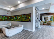 Thumbnail 7 of 31 - A living room with a large painting of green plants on the wall.at Tiffany Flats, Columbus, Ohio