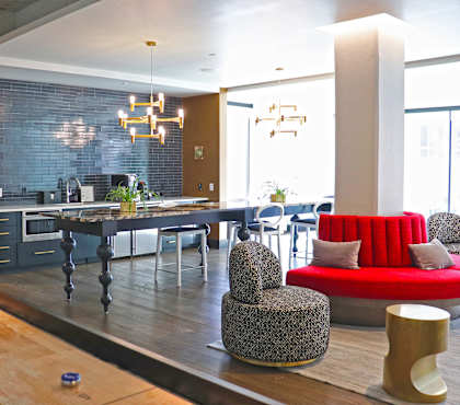 A modern dining area with a long table and chairs.