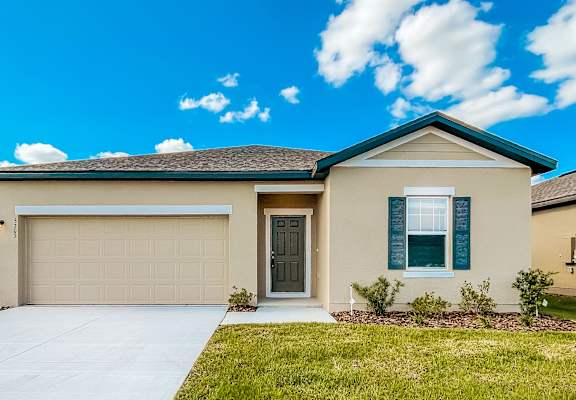 A house with a garage door and a brown door.