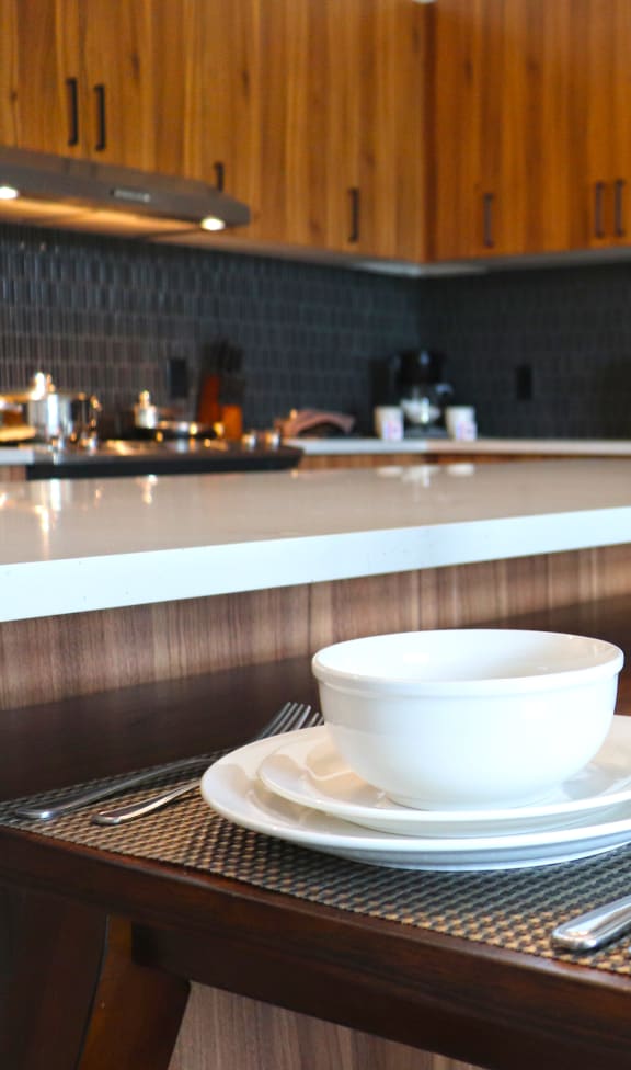 a dining table with dishes and glasses in a kitchen at Wildhorse Apartments, Missouri, 63017