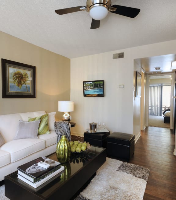 a living room with a white couch and a coffee table