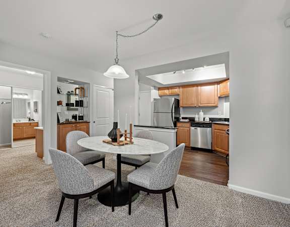 A modern kitchen with a dining table and chairs.