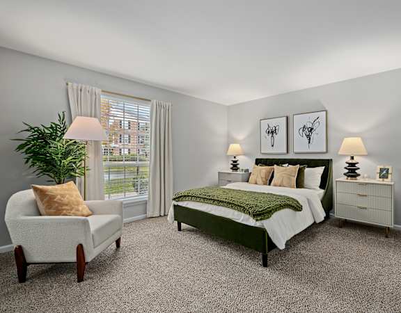 A bedroom with a bed, nightstand, chair, and lamp.