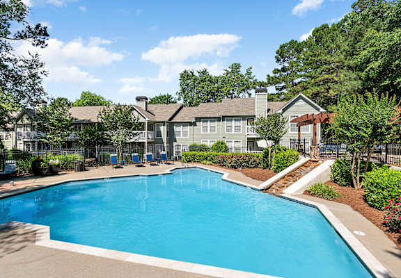 a swimming pool with a building in the background