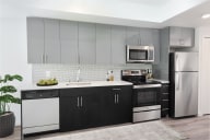 a kitchen with white countertops and black and white cabinets