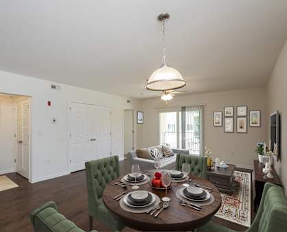 an open living room and dining room with a table and chairs