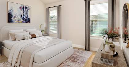 a bedroom with white walls and a white bed