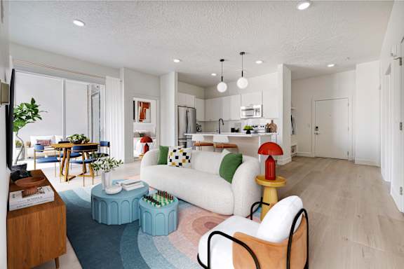 A modern living room with a white sofa, a wooden side table, and a blue rug.