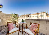 Thumbnail 4 of 5 - Two chairs with pink pillows are on a patio.