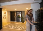 Thumbnail 8 of 8 - a man and a woman standing in a lobby holding a briefcase