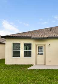 A house with a brown roof and a white door.