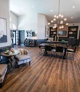 A large room with a wooden floor and a painting on the wall.
