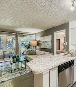 A spacious room with a carpeted floor and a white door.