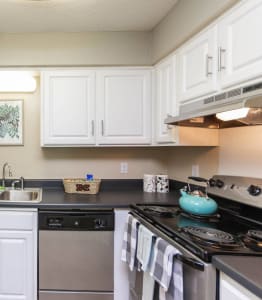 a kitchen with stainless steel appliances and white cabinets