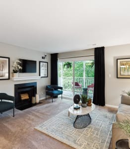 a living room with a couch and chairs and a fireplace