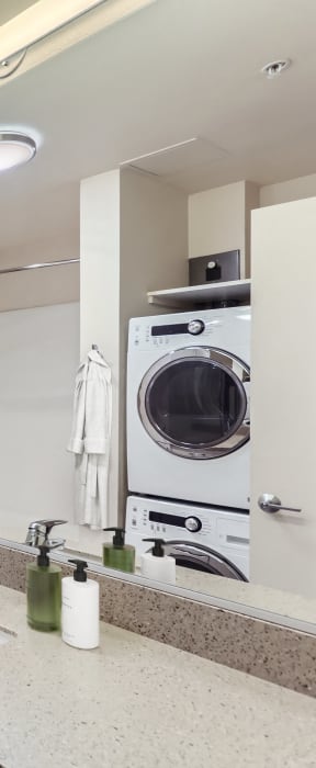 a bathroom with a sink and a toilet and a washing machine