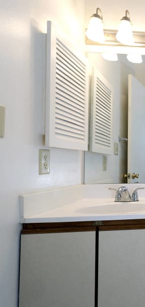 a bathroom with a sink toilet and mirror and a bath tub