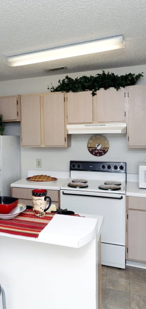 a kitchen with white appliances and a white counter top