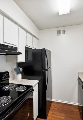 a kitchen with a stove and a refrigerator and a sink at Great Hills, Austin
