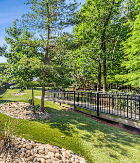 A well-maintained garden with a small stream running through it.