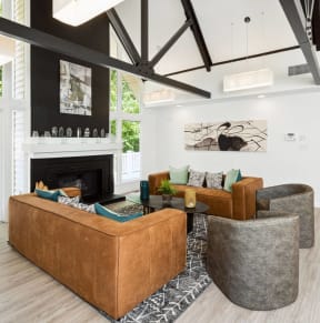 a living room with couches and chairs and a fireplace