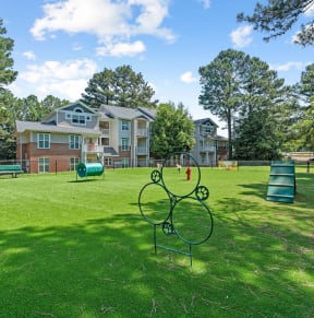 a large yard with a park and houses in the background