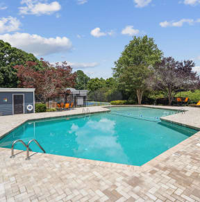 a swimming pool in the backyard of a house with a pool