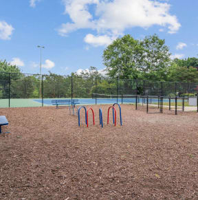 a park with a playground and a tennis court