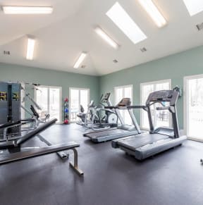 the gym with treadmills and other exercise equipment at the belgard apartments