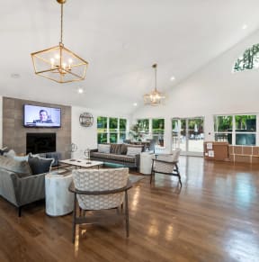 a living room with couches and chairs and a fireplace