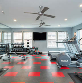 a gym with a bunch of chairs and a ceiling fan
