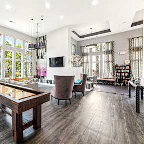 A modern living room with a long wooden table and a television.