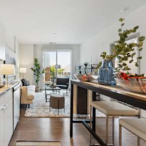 A modern kitchen with a granite countertop and white cabinets.