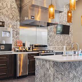 A modern kitchen with a large island and stainless steel appliances.